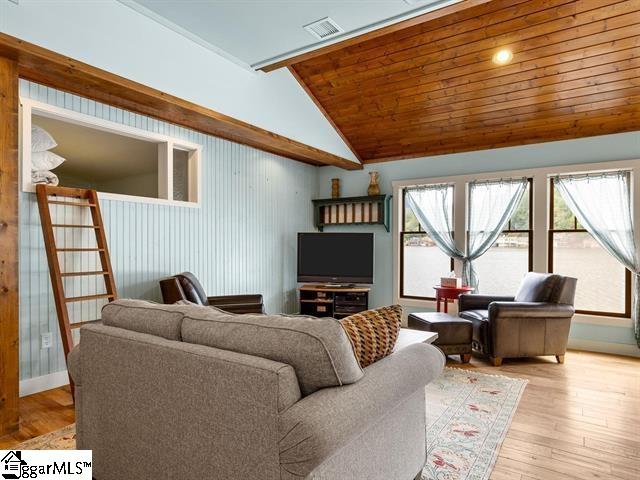 living room featuring wooden ceiling, light hardwood / wood-style flooring, and lofted ceiling