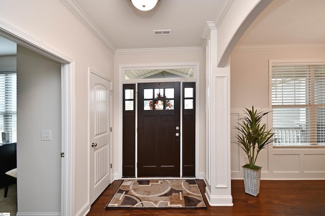 entrance foyer with dark hardwood / wood-style flooring and ornamental molding