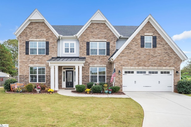 view of front of property with a garage and a front yard