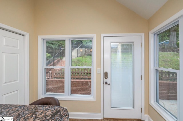 entryway featuring a wealth of natural light and vaulted ceiling