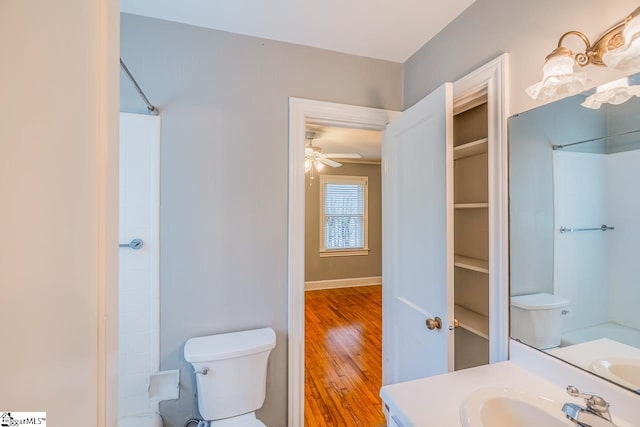 bathroom with vanity, hardwood / wood-style floors, toilet, a shower, and ceiling fan