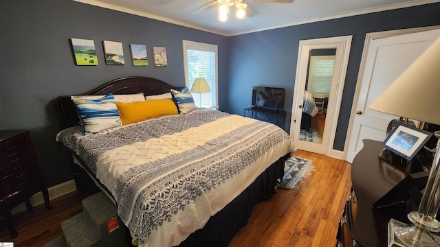 bedroom with ceiling fan, crown molding, and wood-type flooring