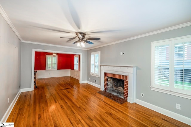 unfurnished living room with a wealth of natural light, hardwood / wood-style flooring, and ornamental molding