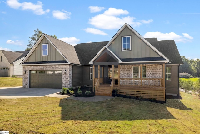 view of front of house featuring a front lawn, a garage, and covered porch