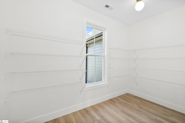 unfurnished room with hardwood / wood-style flooring