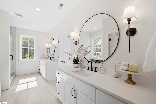 bathroom featuring tile patterned flooring, vanity, and a shower with shower door