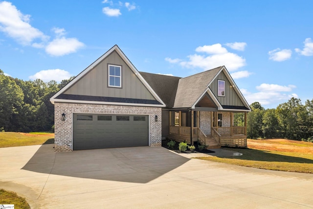 craftsman-style home featuring a garage, a front yard, and covered porch