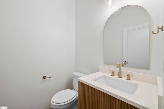 bathroom featuring toilet and vanity