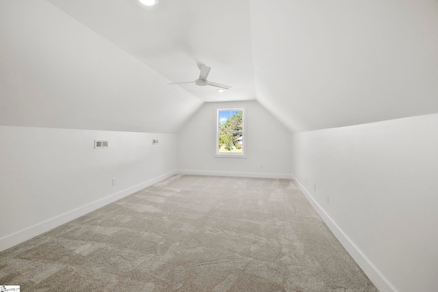 additional living space with vaulted ceiling and light colored carpet