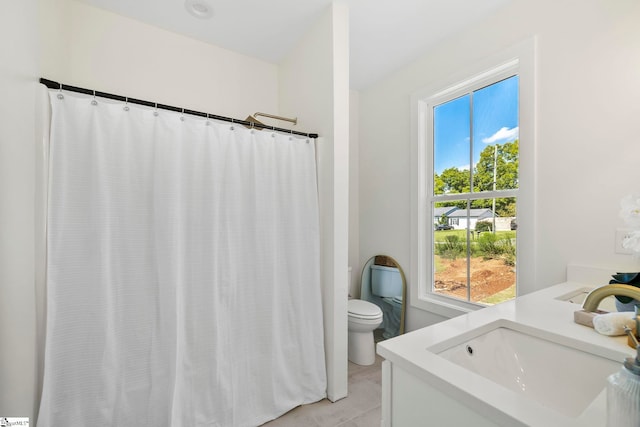 bathroom featuring toilet and vanity