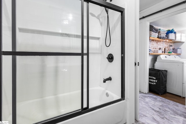 bathroom featuring hardwood / wood-style flooring, washer / clothes dryer, and enclosed tub / shower combo