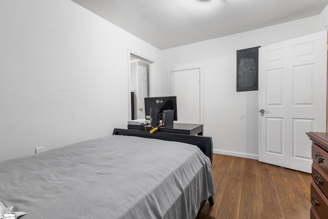 bedroom with dark hardwood / wood-style floors