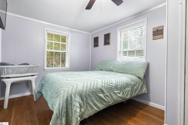 bedroom with ceiling fan, dark hardwood / wood-style flooring, and ornamental molding