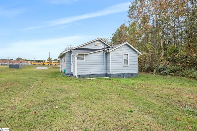 rear view of property featuring a lawn