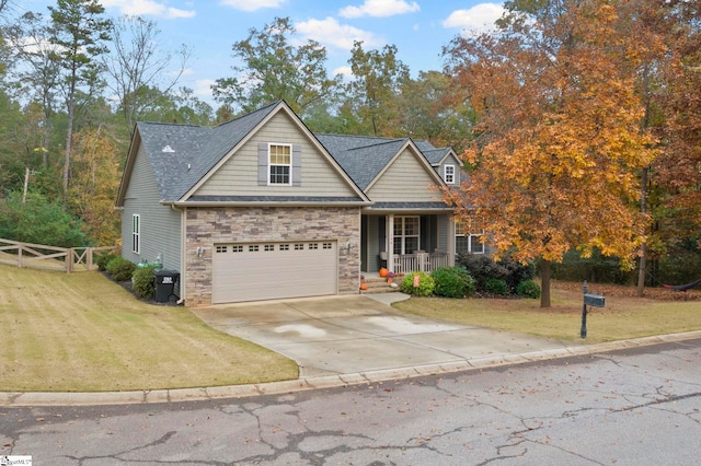 view of front of house featuring a porch, a front lawn, and a garage