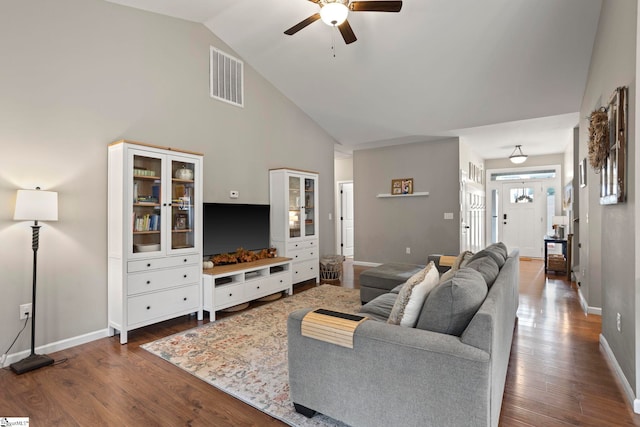 living room with ceiling fan, dark hardwood / wood-style floors, and high vaulted ceiling