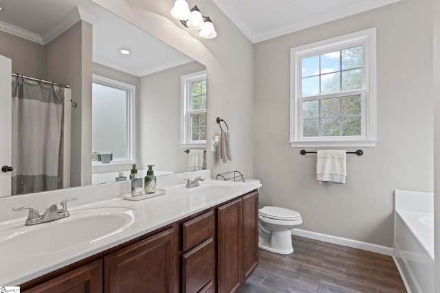 bathroom with wood-type flooring, vanity, crown molding, toilet, and a bathtub