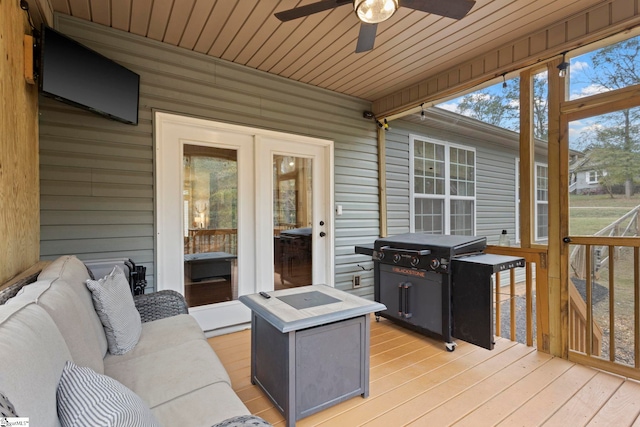 wooden terrace featuring ceiling fan and area for grilling