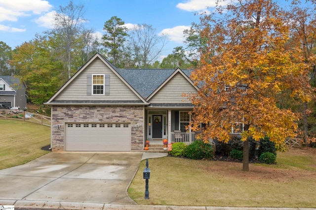 view of front of property featuring a garage, a front yard, and a porch