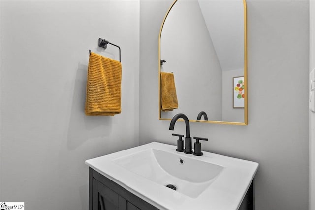 bathroom featuring vanity and vaulted ceiling