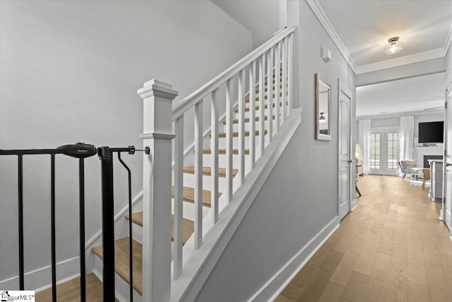 staircase with hardwood / wood-style flooring and crown molding