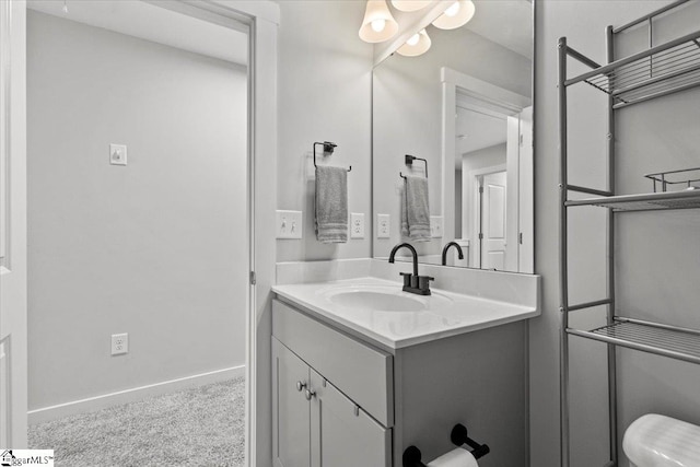 bathroom featuring vanity and toilet