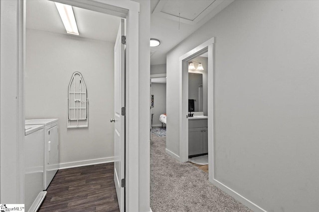 hallway with dark wood-type flooring and independent washer and dryer