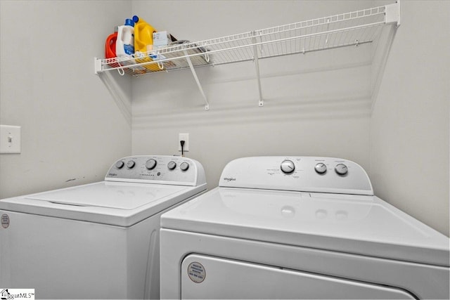 clothes washing area with washing machine and clothes dryer