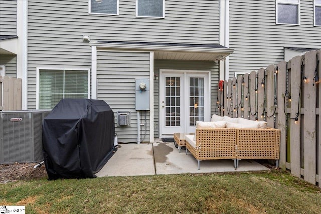 entrance to property featuring outdoor lounge area, central AC, a yard, and a patio area