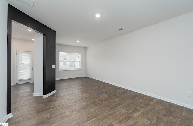 spare room featuring dark hardwood / wood-style floors