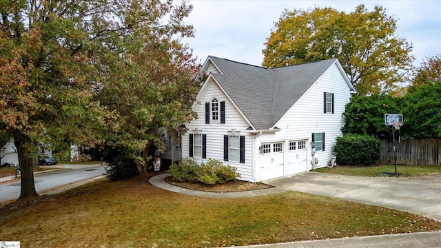 view of front of house with a garage and a front yard