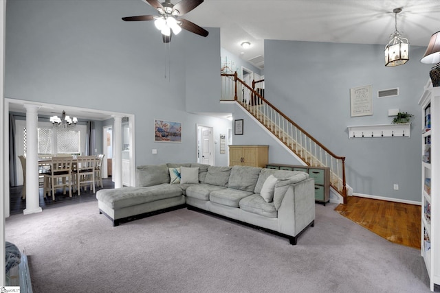 living room with ceiling fan, carpet flooring, ornate columns, and high vaulted ceiling