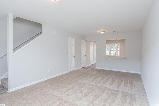 unfurnished room featuring carpet