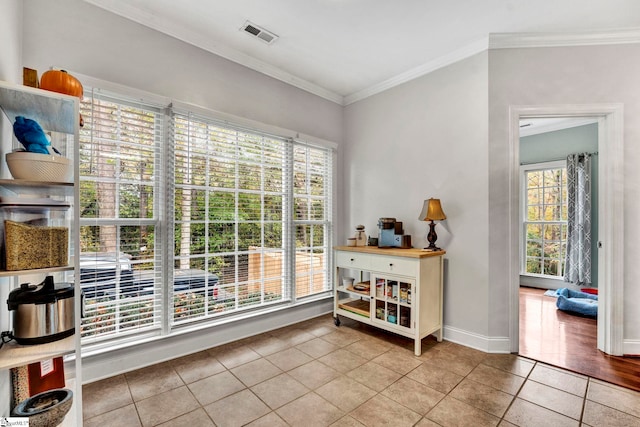 doorway to outside with light tile patterned floors and crown molding