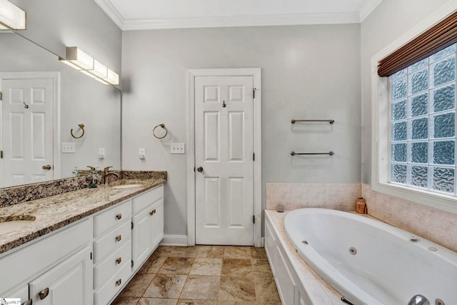 bathroom featuring tiled bath, crown molding, and vanity