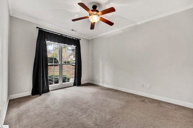 empty room with ceiling fan, carpet, and crown molding