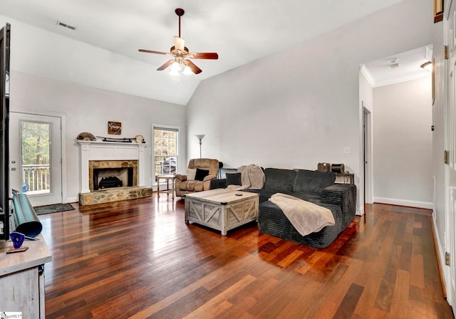 living room featuring a fireplace, ceiling fan, dark wood-type flooring, and lofted ceiling