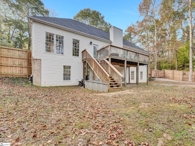 rear view of property featuring a deck