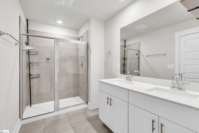 bathroom featuring vanity, tile patterned floors, and a shower with shower door