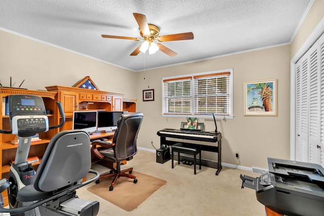 carpeted home office with ceiling fan, a textured ceiling, and ornamental molding