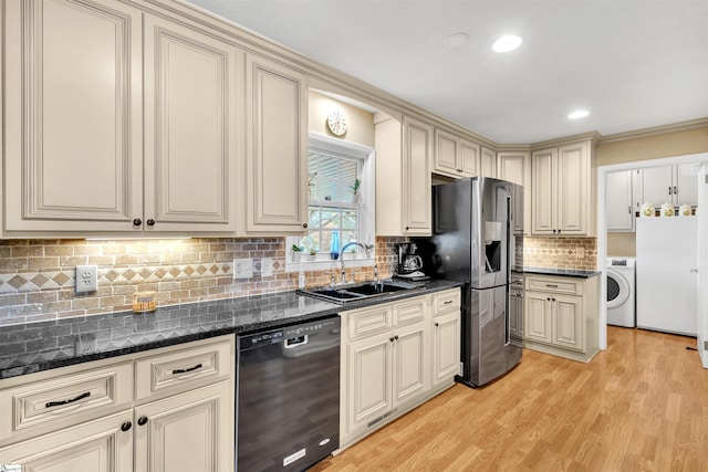 kitchen featuring sink, cream cabinets, washer / clothes dryer, light wood-type flooring, and dishwasher