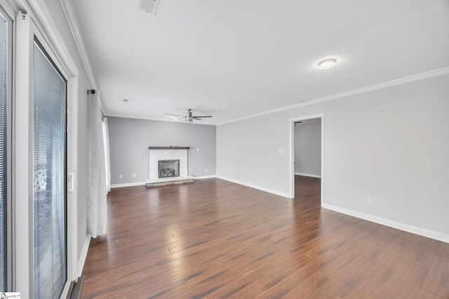 unfurnished living room featuring a textured ceiling, dark wood-type flooring, ceiling fan, and crown molding