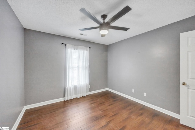 unfurnished room featuring ceiling fan, a textured ceiling, and dark hardwood / wood-style flooring