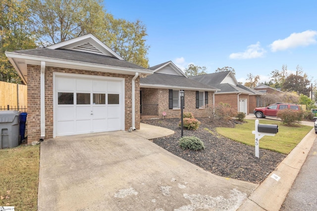 ranch-style home featuring a garage and a front yard