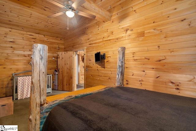 bedroom featuring beamed ceiling, wooden walls, and ceiling fan