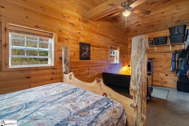 bedroom featuring vaulted ceiling with beams, wood walls, wooden ceiling, ceiling fan, and a closet