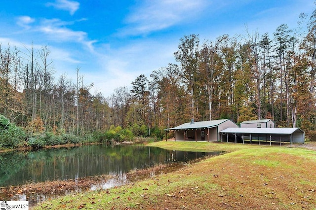 view of yard with a carport and a water view