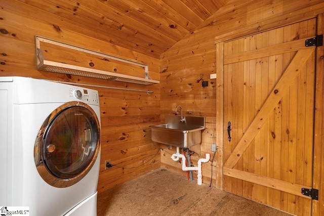 laundry area featuring carpet flooring, wood ceiling, wooden walls, sink, and washer / clothes dryer