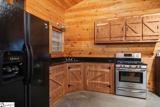 kitchen featuring lofted ceiling, gas range, wooden walls, concrete flooring, and black fridge with ice dispenser