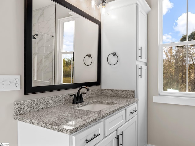 bathroom featuring vanity and a tile shower